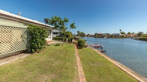 A residential area with a house, a lawn, a water body, and a dock. - 114 Elizabeth on the Forster Keys (Forster)