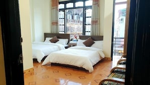 A hotel room with two beds, a wooden floor, and large windows with curtains. - Minh Quan Sapa Hotel - by Bay Luxury (Sa Pa)