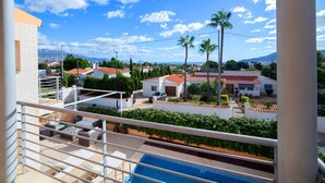 A residential area with a pool, white buildings, and palm trees. - Casa Viena by Interhome (Albir)