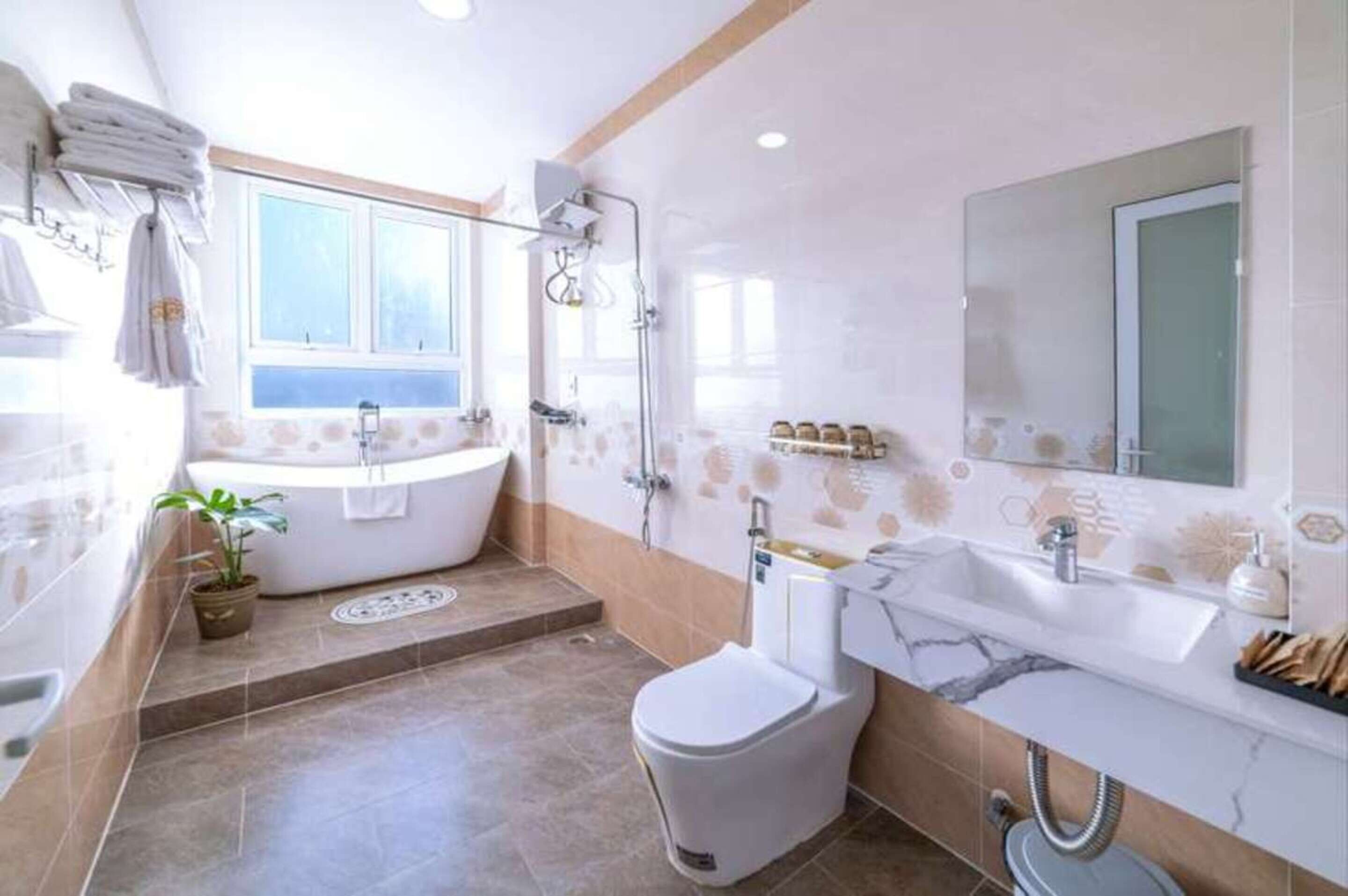 A modern bathroom with a bathtub, toilet, and sink.