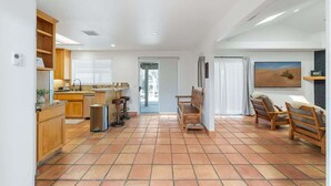 A spacious living area with a kitchen, a dining table, and a fireplace.