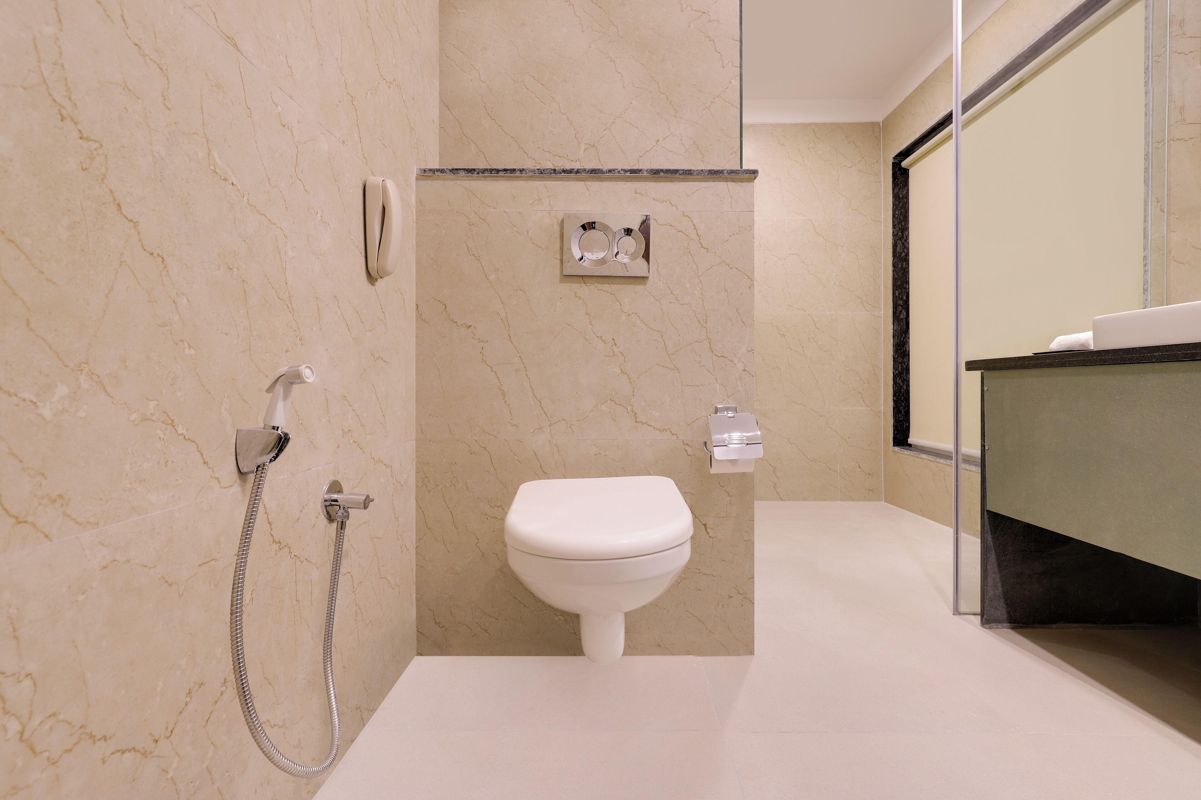 A modern bathroom with a toilet, a shower, and a sink.