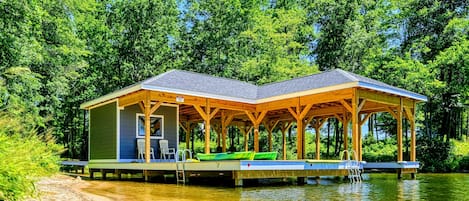 Charming lakeside boathouse with seating area and easy water access, perfect for relaxation and recreation