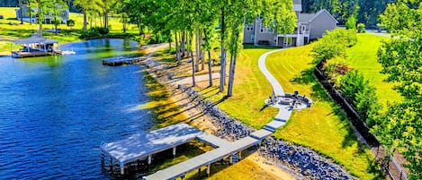 From Above - The full property in a single frame: private dock, sandy beach, fire pit, and quiet cove out front.