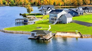 Une propriété au bord du lac comprenant plusieurs maisons, un quai et une zone herbeuse.