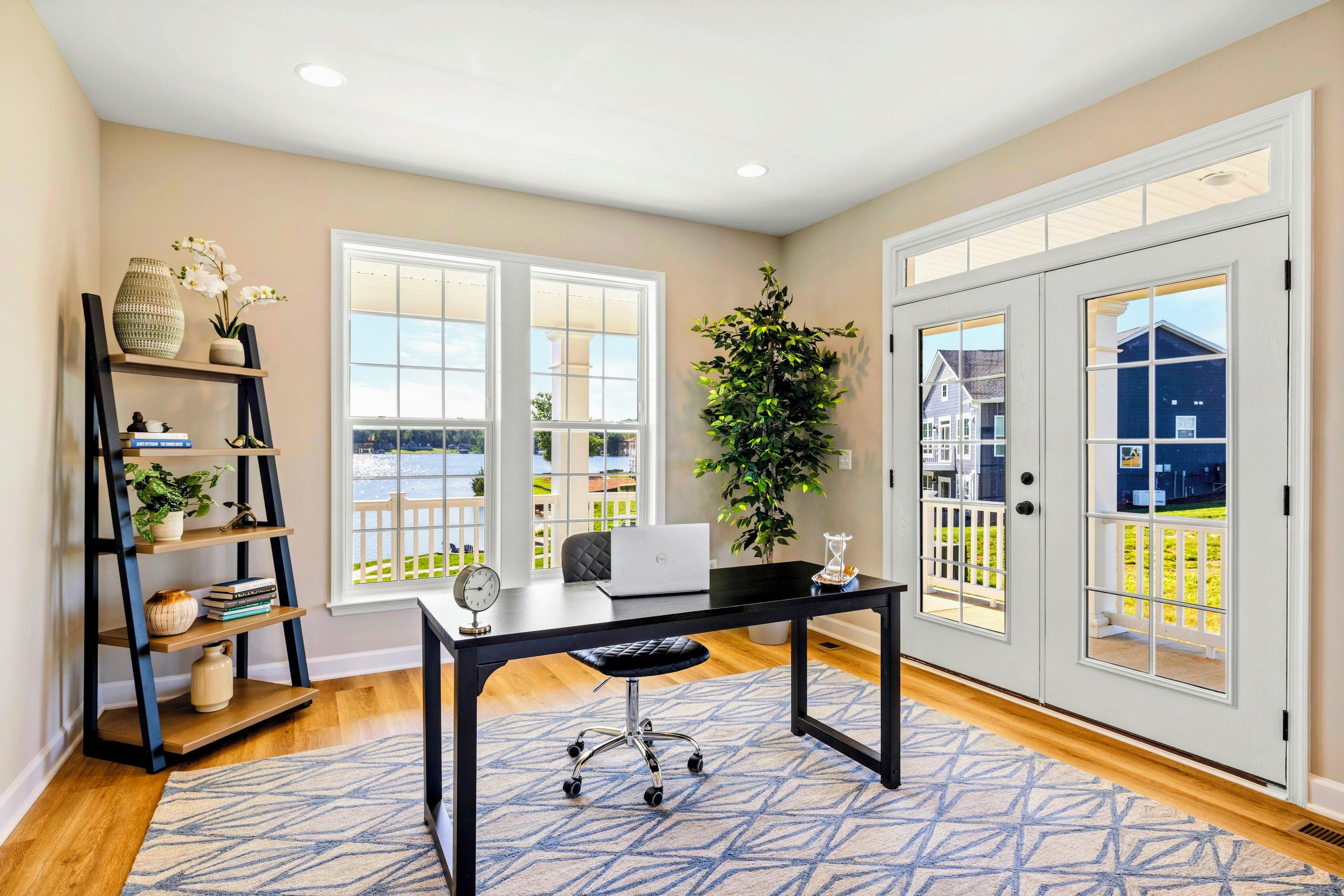 A home office with a desk, computer, and bookshelf.