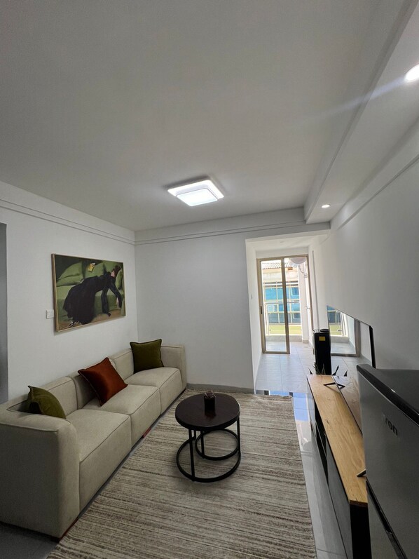 Business Apartment | Living area | 24-inch Smart TV with digital channels - Lux Suites Gold Park Apartments Kilimani (Nairobi)