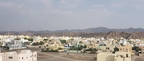 A cityscape with buildings and mountains in the background.