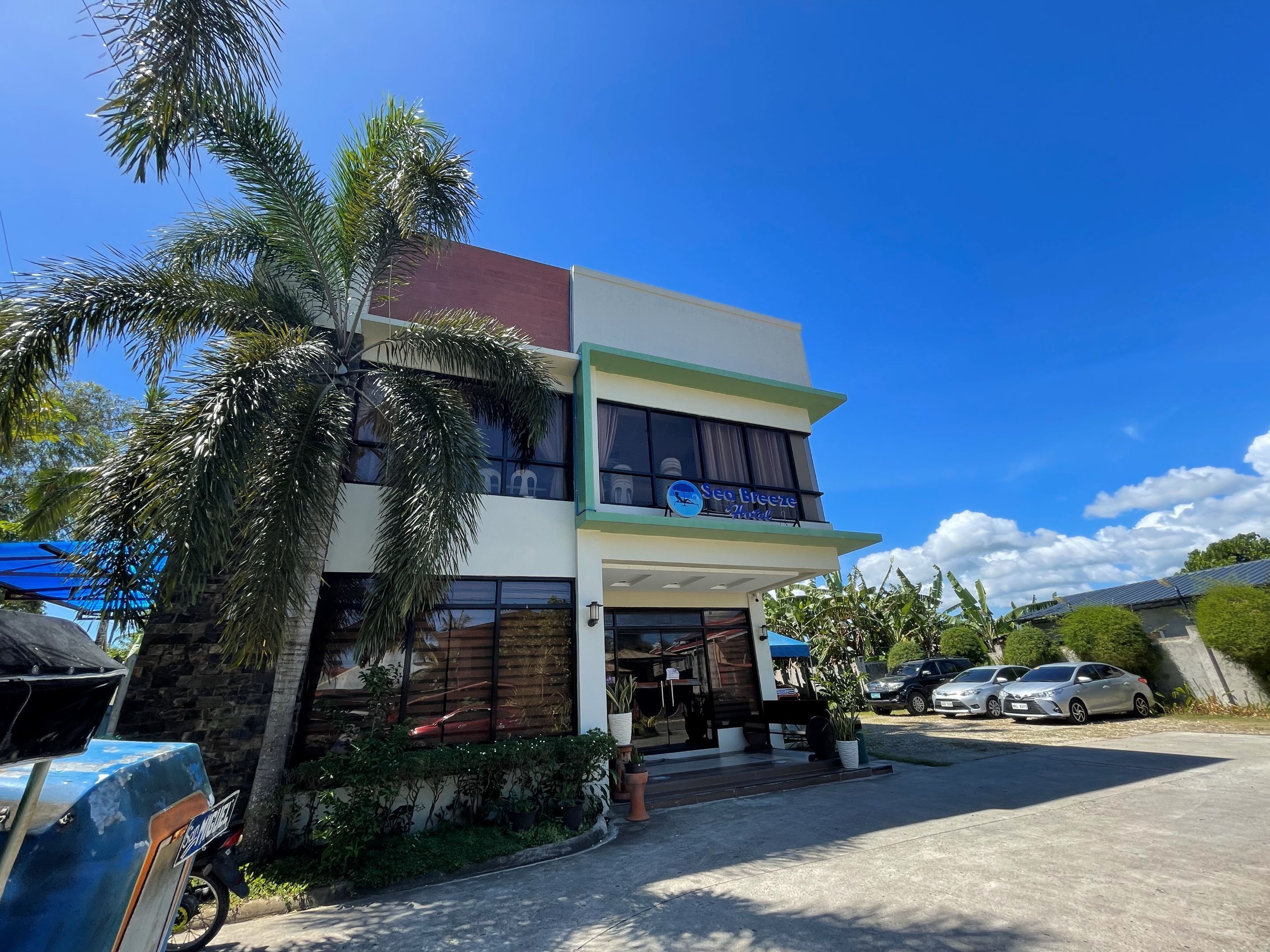 A two-story building with a sign for "Sea Breeze Hotel".