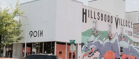 A building with a mural of a dinosaur and the text "HILLSBORO VILLAGE EST. 1920".