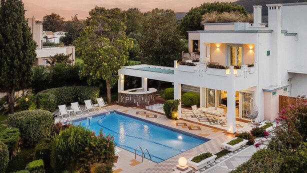 A modern two-story house with a swimming pool, outdoor seating, and a well-maintained garden. - Beachfront " Villa Io " (Katerini)