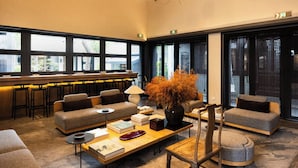A modern lounge area with sofas, a coffee table, and a large window providing a view of the outside. - Jiangnan House Guanqianjie  (Suzhou)