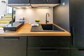 Fridge, stovetop, dishwasher, coffee/tea maker