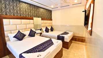 Deluxe Quadruple Room | Laptop workspace, bed sheets