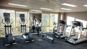 A gym with treadmills, elliptical machines, and weight machines. - City Central Canberra Unit (Canberra)