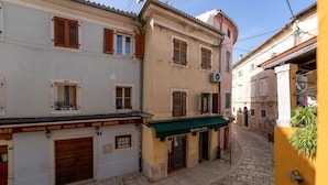 A narrow cobblestone street with traditional buildings, a wine cellar, and a Bacchus shop. - Modern apartment for 2 persons in the Porec old town , only 150m from the beach. (Porec)