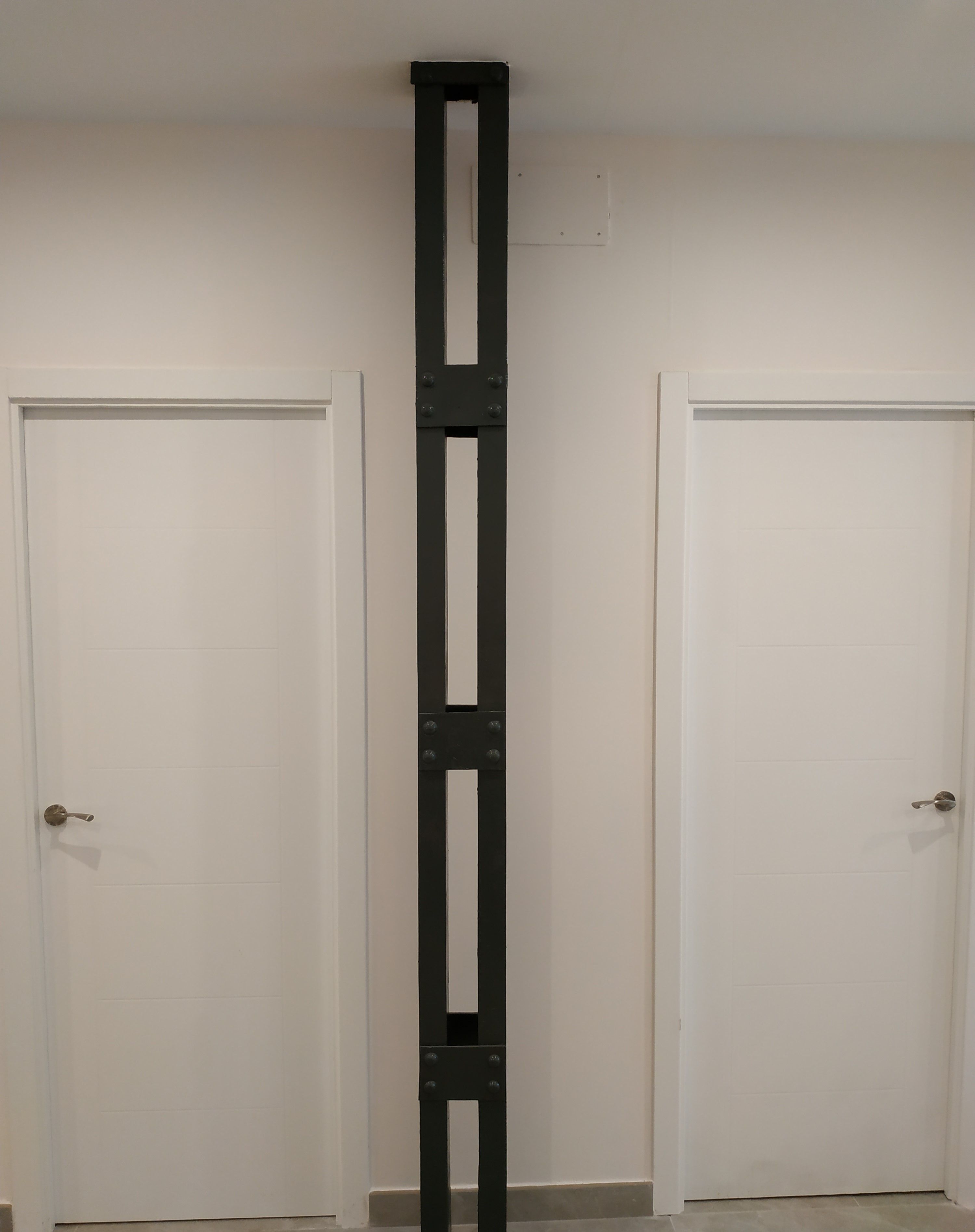 A white door with a black metal handle and a white door with a black metal handle.