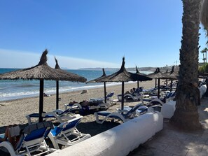 On the beach, sun loungers, beach towels