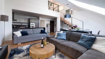 Luxury Apartment | Living area | 16-inch flat-screen TV with cable channels