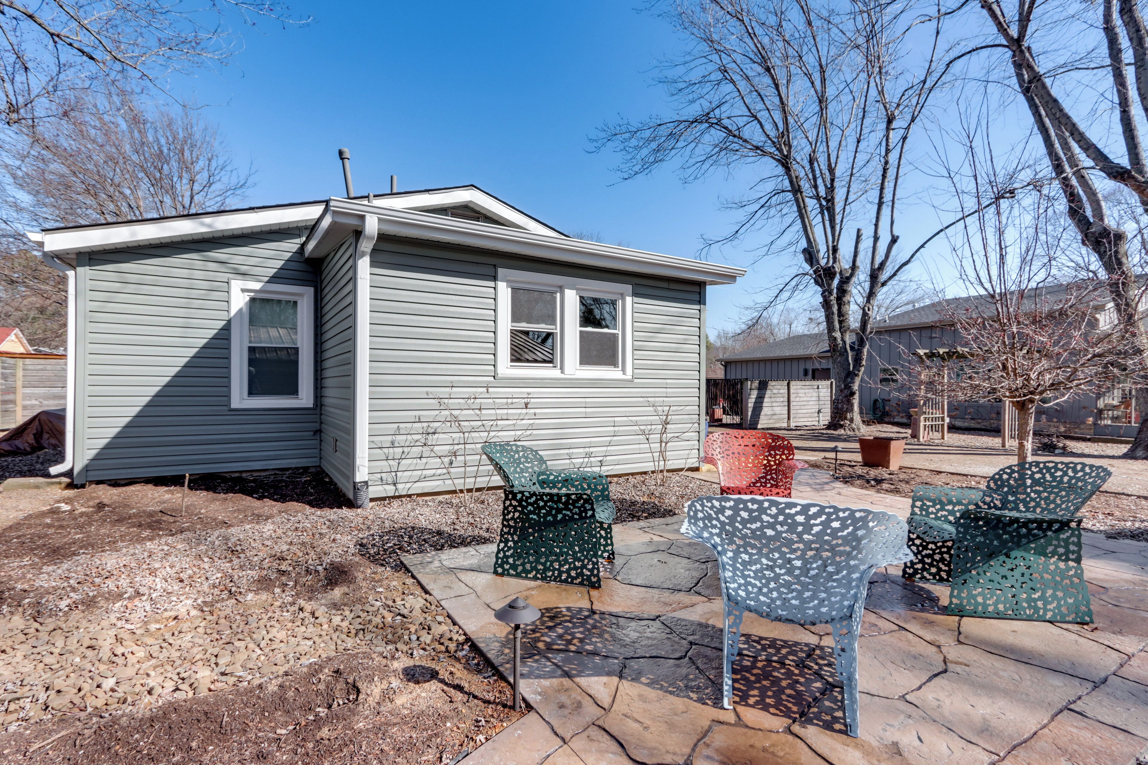 A small house with a patio area featuring outdoor furniture.