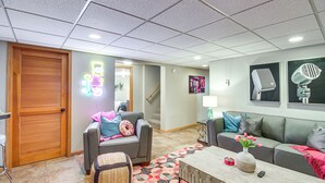 A modern living room with a gray sofa, a coffee table, and a patterned rug. - Spacious Detroit Lakes Home: Walk to Downtown! (Detroit Lakes)