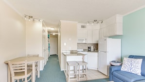 A compact living space with a kitchenette, a dining area, and a seating area. - Galveston Condo w/ Beach Access Near Moody Gardens (Galveston)