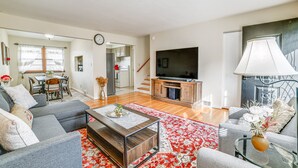 A modern living room with a sofa set, a coffee table, and a TV.