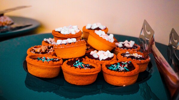 A tray of mini pies with various toppings.