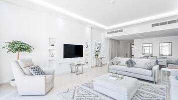 Family Villa | Living area | 55-inch Smart TV with cable channels