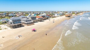 A beachside property with multiple houses, a pier, and a sandy beach. - SeaScape Haven - Right on the sandy BEACH, Hot Tub! (Surfside Beach)