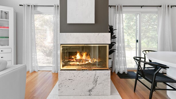 A modern living room with a fireplace, white furniture, and large windows. - Enjoy a stylish experience at this fresh and clean  lower apartment!  This place is newly renovated and perfect for a stay in the Metro Detroit. It's located near the Detroit Zoo right by major highways. This home is a duplex building and includes 2 (Oak Park)
