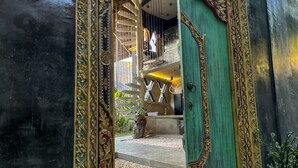 A grand entrance with ornate golden railings and a green door. - Happiness Kulambo Villa El Nido (El Nido)