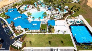 An aerial view of a resort with a large swimming pool, multiple water slides, and a basketball court. - Lake Shore 5BR Resort Villa • Pool • Game Loft (Davenport)