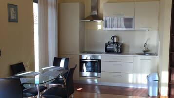 Comfort Apartment | Private kitchen | Full-size fridge, microwave, stovetop, electric kettle