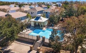A residential area with a swimming pool, a gazebo, and a staircase leading to a deck.