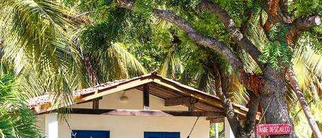 A house with a hammock, a pool, and a sign with various phrases.