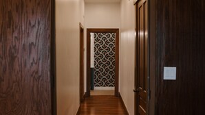 A hallway with wooden flooring and doors, leading to a room with a patterned wall. - Oregon District Oasis - The Best of Downtown (Dayton)