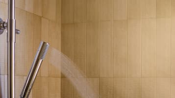 A shower with a handheld showerhead and a fixed overhead showerhead.