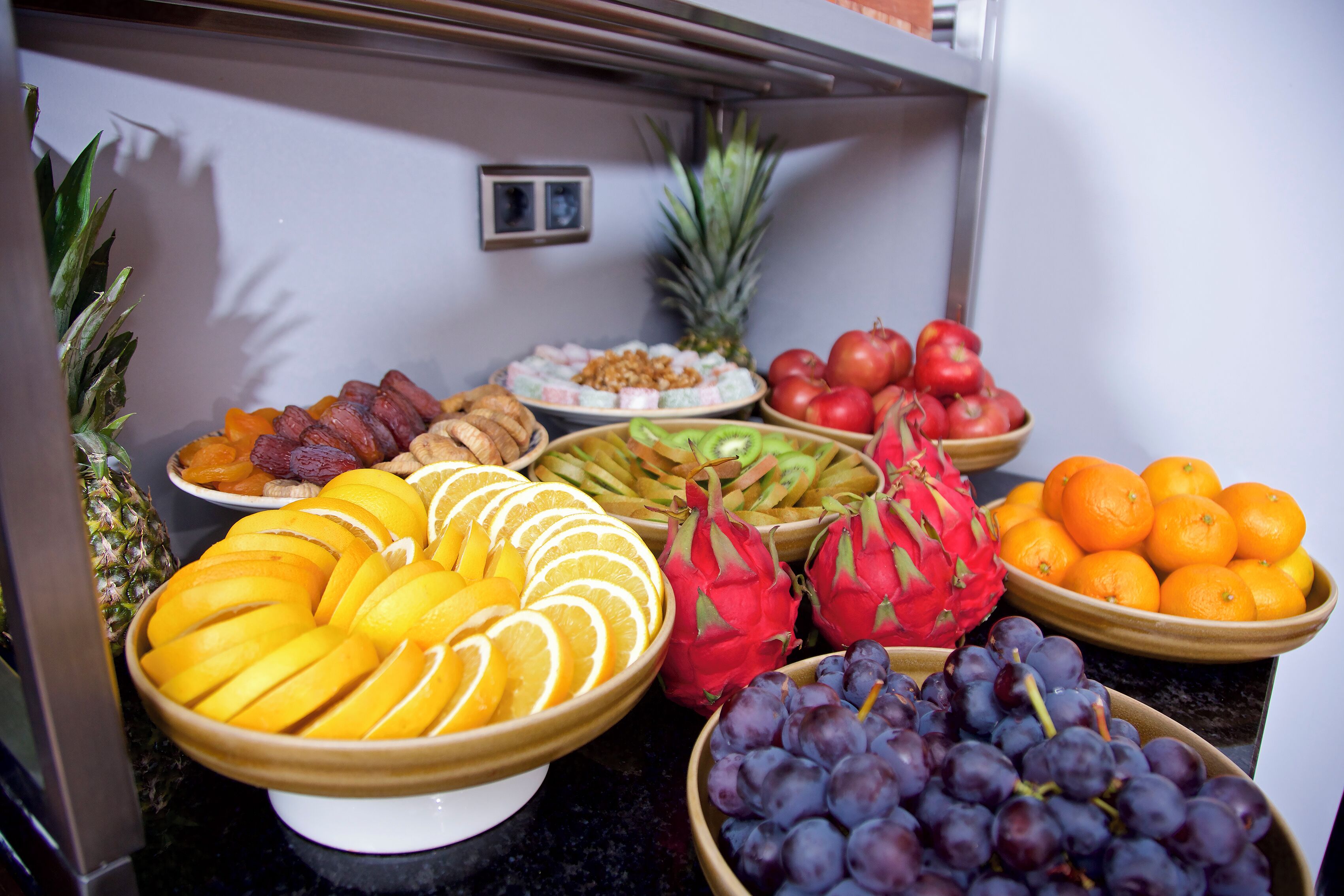 A buffet with various fruits and vegetables.