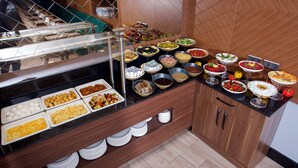 A buffet with various food items and a glass display case. - Downtown Sirkeci Hotel (Istanbul)