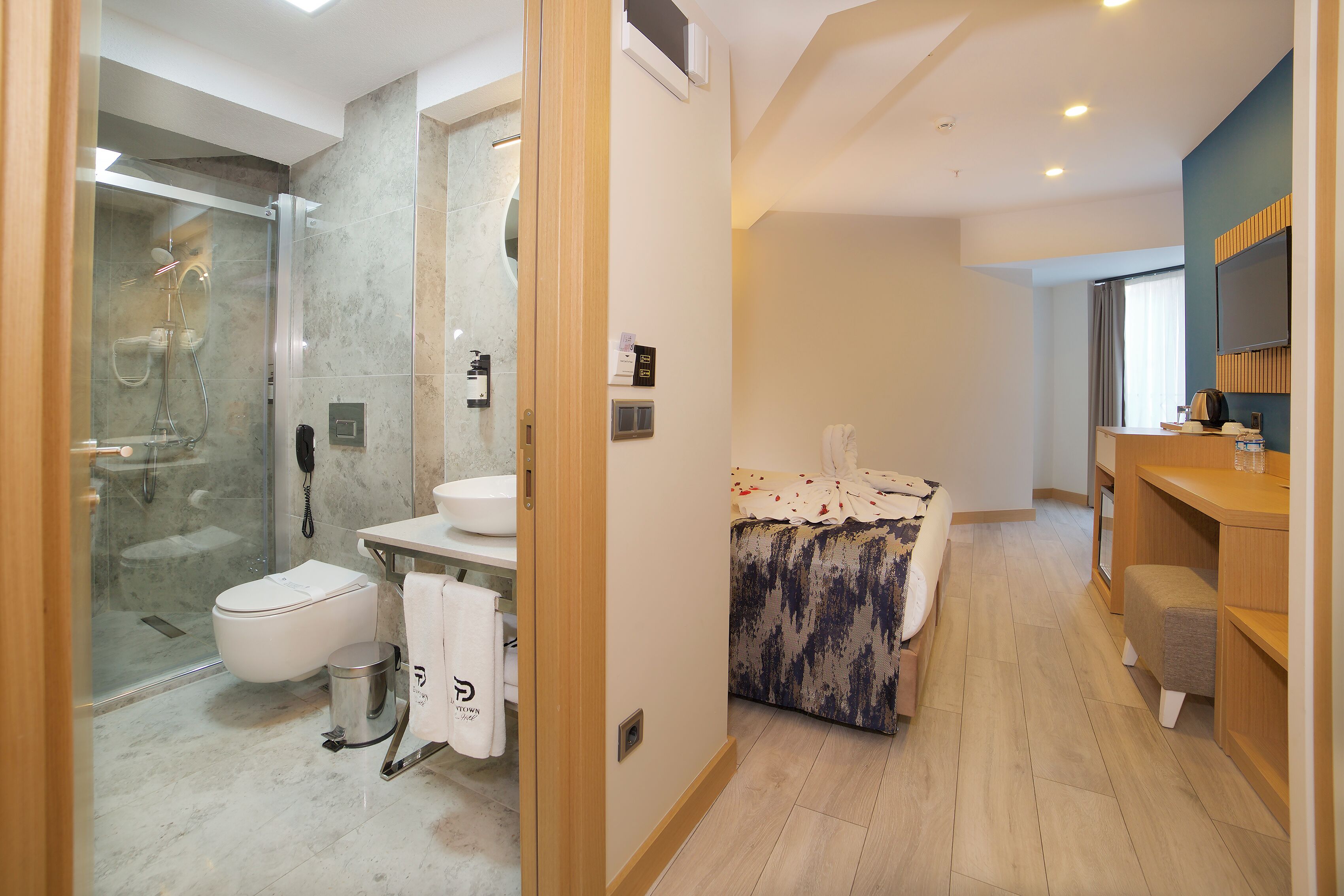 A modern bathroom with a shower, toilet, and sink.