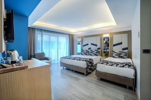 A hotel room with two beds, a desk with a coffee maker, a TV, and a large window with curtains. - Downtown Sirkeci Hotel (Istanbul)