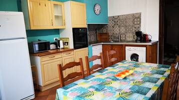 A compact kitchen with wooden cabinets, a microwave, a toaster, and a coffee maker.