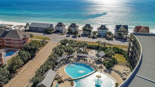 A resort with a swimming pool, beachfront villas, and a view of the ocean. - Gulf Views - Beach Chair Service - Zero Entry Pool + Hot Tub - Beach Resort 403 (Miramar Beach)