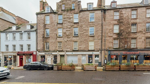 A stone building with multiple shops on the ground floor, including a craft beer pub. - Perth Penthouse at the Concert Hall (Perth and Kinross)