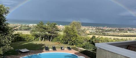 Seasonal outdoor pool, open 8:00 AM to 8:00 PM, pool umbrellas