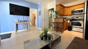 A modern kitchen with wooden cabinets, a built-in oven, and a microwave. - ATTENTION: Frequent Island wide power outages likely! Summer/Fall 2026. (Nassau)