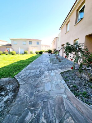 Stroll through a serene residential area lined with manicured lawns and two-story homes.