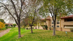 A residential area with multiple houses, each featuring a red-tiled roof and beige walls. - Pickleball, 3 pools & hot tubs, gated community, free parking, New listing.  (Phoenix)