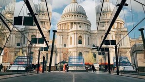 A large, historic building with a prominent dome, viewed through a modern glass structure. - Ideally located cosy flat (London)